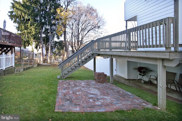 view of yard featuring a patio and a wooden deck