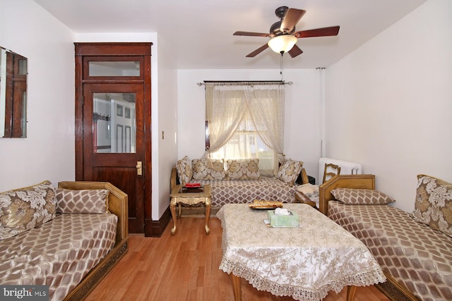 living room with light wood-type flooring and ceiling fan