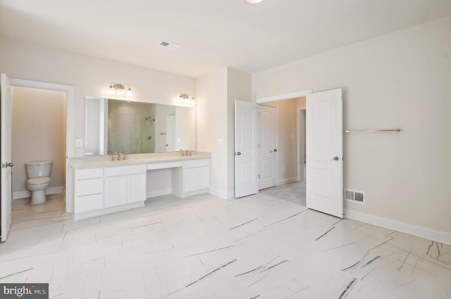 bathroom featuring walk in shower, vanity, and toilet