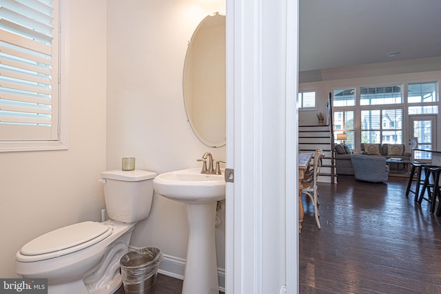 bathroom with hardwood / wood-style floors, toilet, and sink