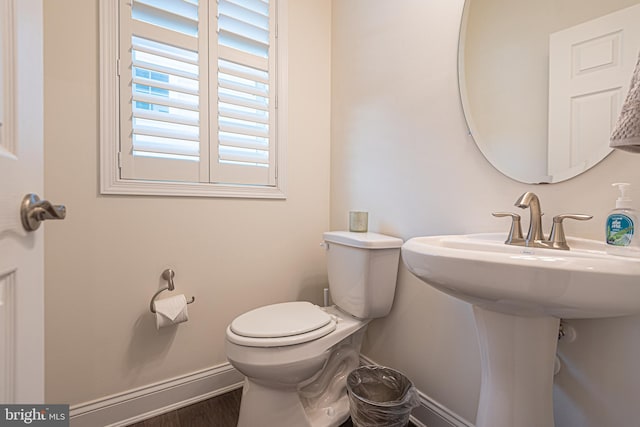 bathroom featuring hardwood / wood-style floors and toilet