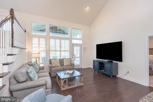 living room featuring high vaulted ceiling and dark hardwood / wood-style floors