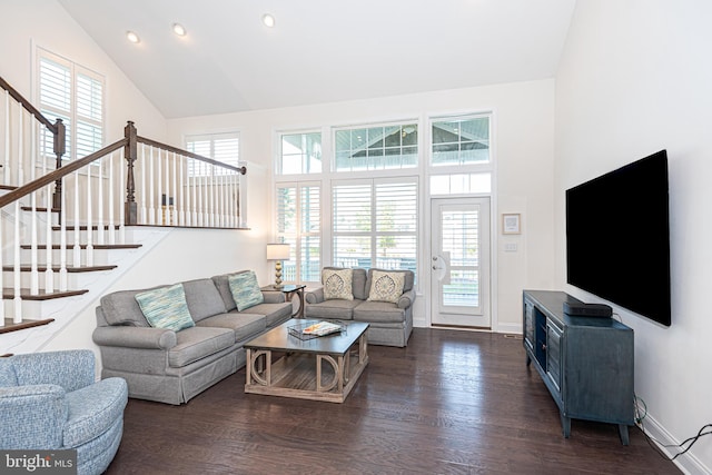 living room featuring dark wood-type flooring, high vaulted ceiling, and a healthy amount of sunlight