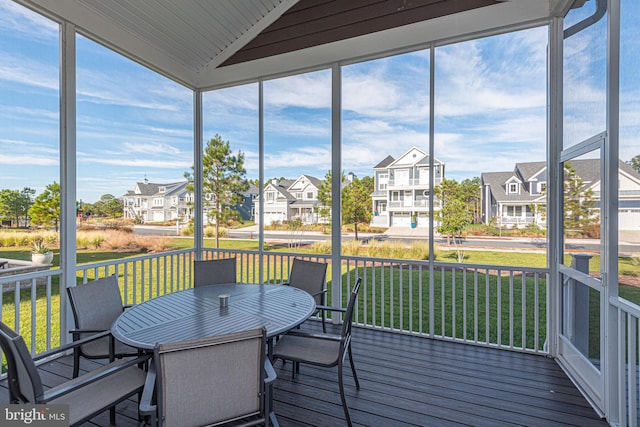 sunroom featuring a wealth of natural light and vaulted ceiling