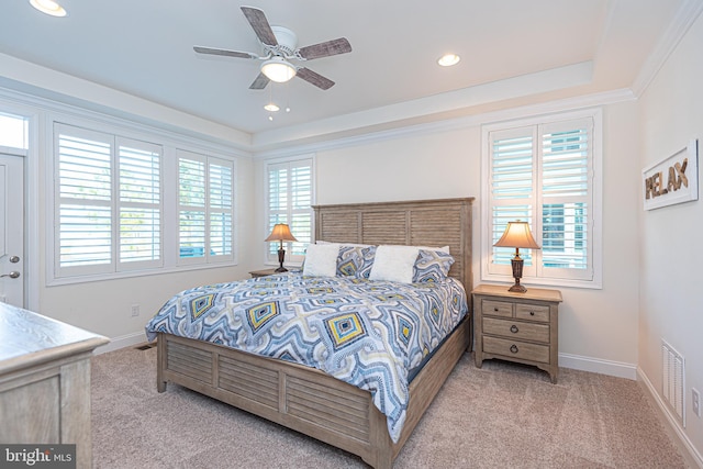 carpeted bedroom featuring ceiling fan and crown molding