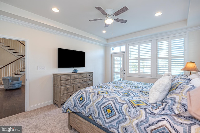 carpeted bedroom featuring ceiling fan and ornamental molding