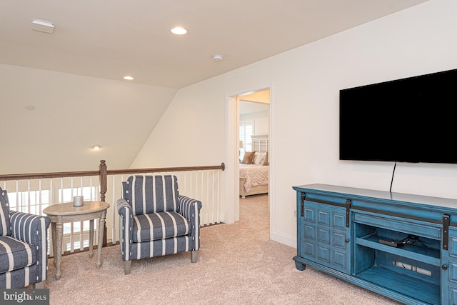 sitting room featuring a wealth of natural light, light carpet, and lofted ceiling