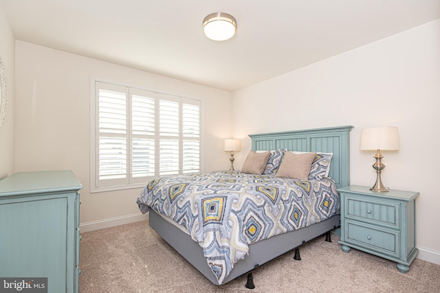 bedroom featuring light carpet