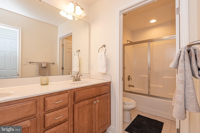 full bathroom featuring tile patterned flooring, vanity, bath / shower combo with glass door, and toilet