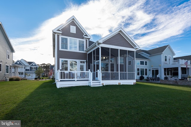 back of house featuring a sunroom and a yard