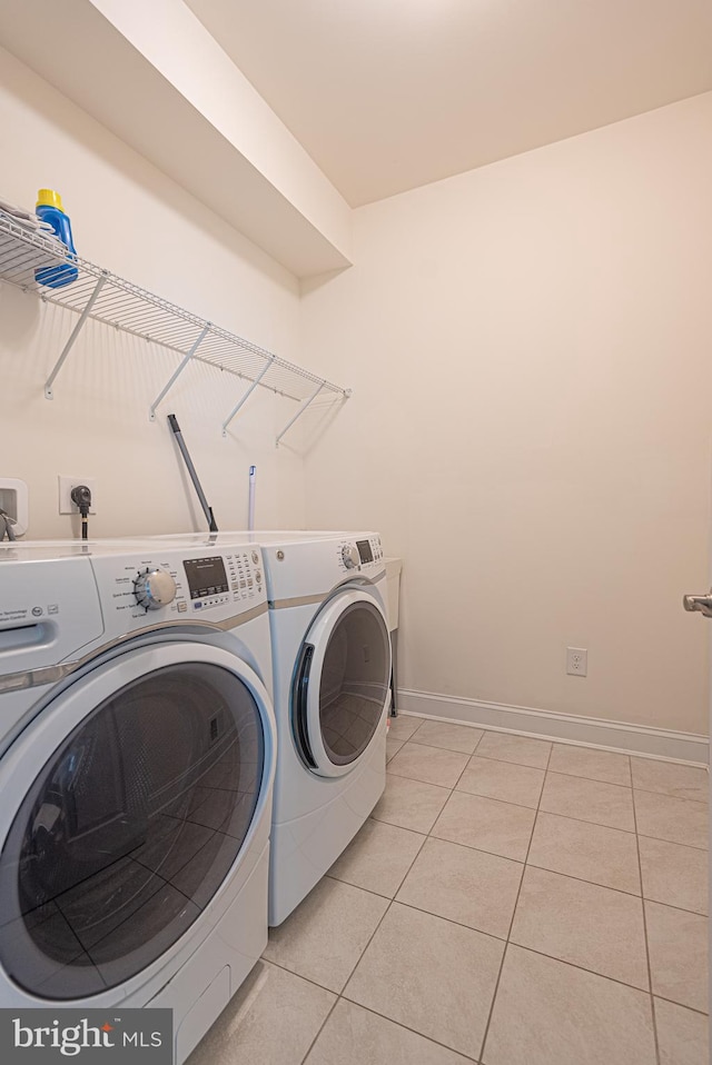 washroom featuring light tile patterned floors and separate washer and dryer