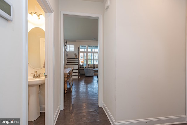 hallway with dark wood-type flooring and sink