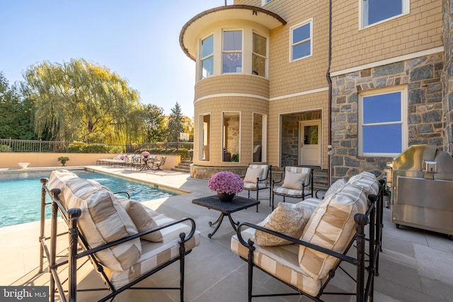 view of patio / terrace with a grill and a fenced in pool