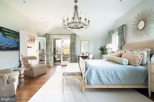 bedroom with access to exterior, wood-type flooring, an inviting chandelier, and lofted ceiling