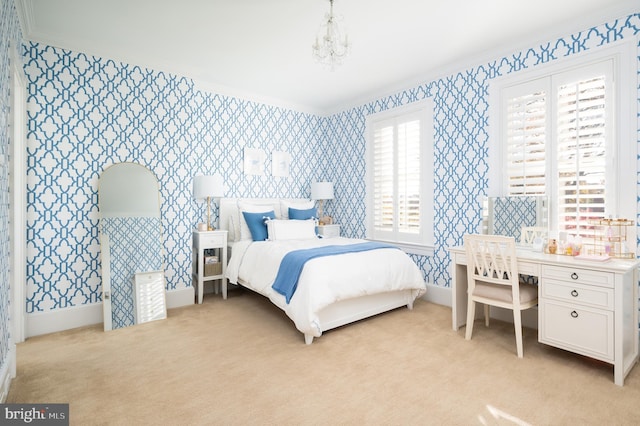 carpeted bedroom featuring a notable chandelier and ornamental molding