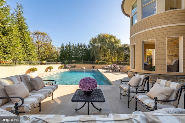 view of pool featuring pool water feature and a patio area