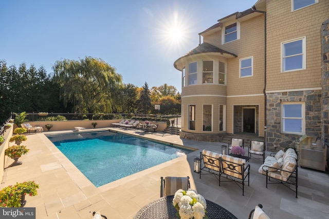 view of pool with an outdoor living space and a patio area