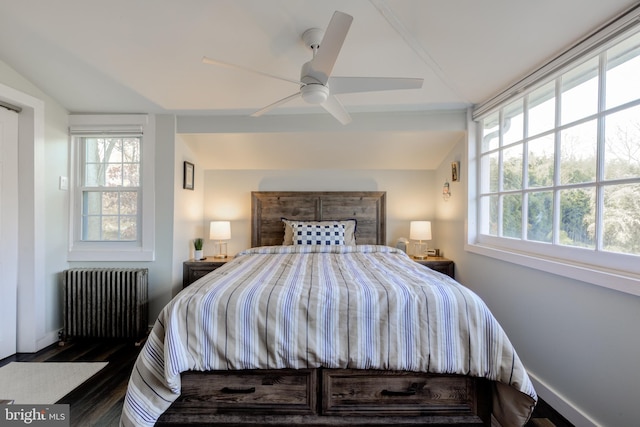 bedroom featuring radiator heating unit, lofted ceiling, ceiling fan, and dark wood-type flooring