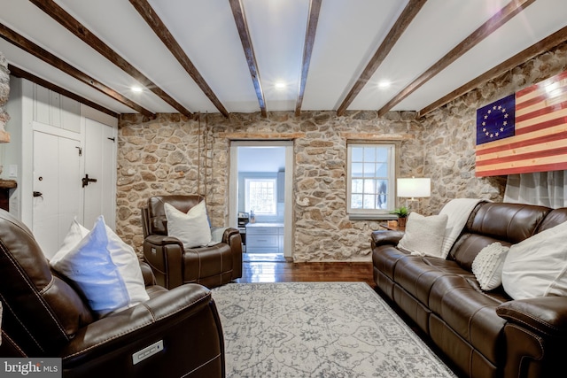 living room featuring wood-type flooring and beam ceiling