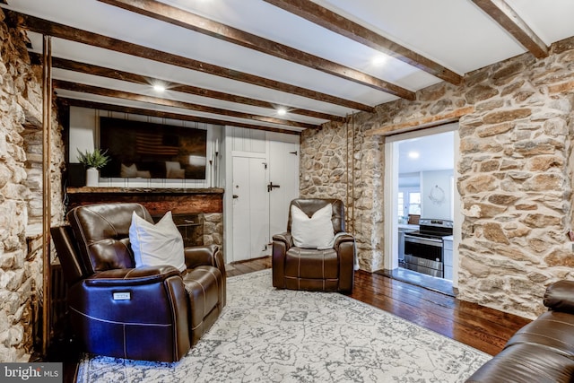 living room with beamed ceiling and hardwood / wood-style flooring