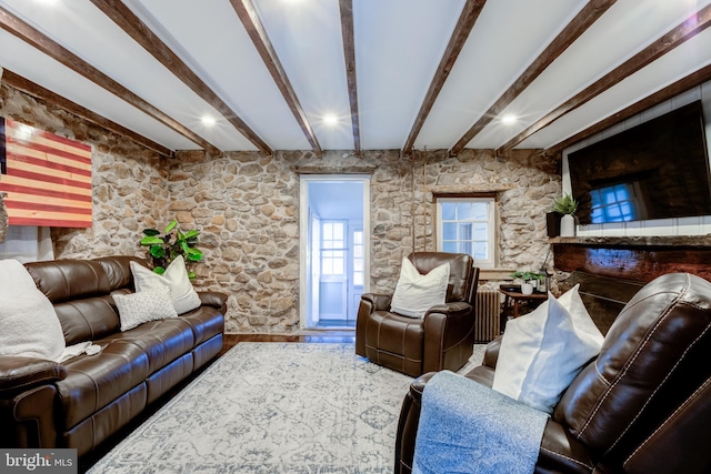 living room featuring radiator, beamed ceiling, and hardwood / wood-style flooring