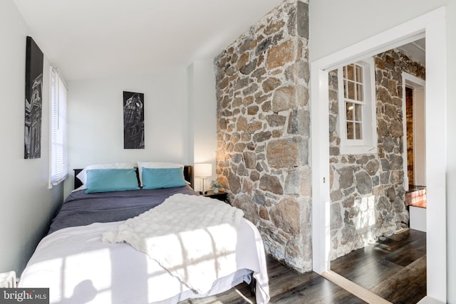 bedroom with dark wood-type flooring