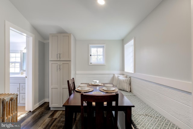 dining space with dark hardwood / wood-style flooring and breakfast area