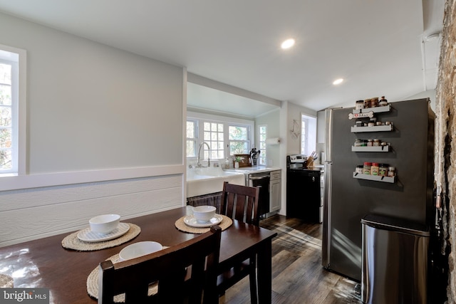 dining room with dark wood-type flooring and vaulted ceiling