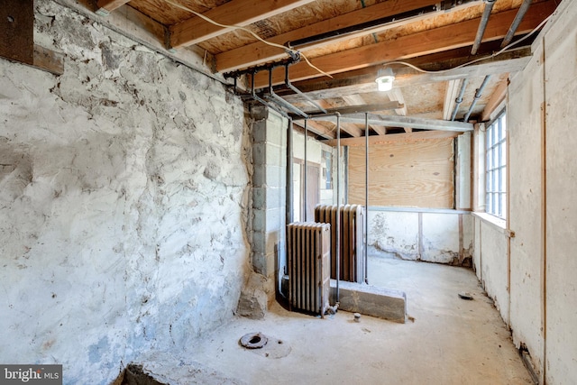 misc room featuring concrete flooring and radiator