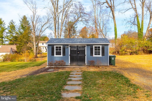 view of outbuilding featuring a lawn