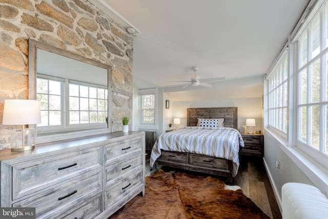 bedroom featuring radiator heating unit, ceiling fan, and dark wood-type flooring