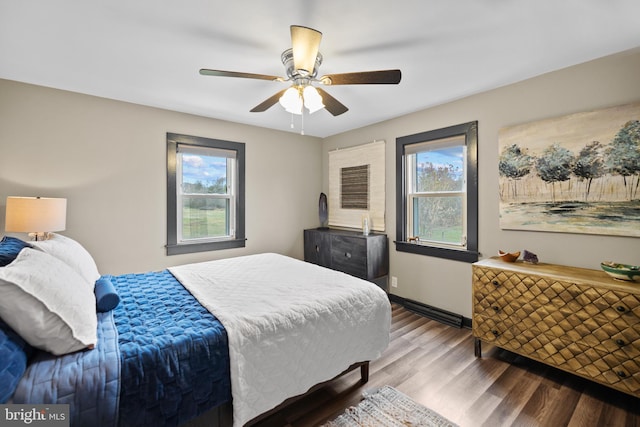 bedroom with hardwood / wood-style floors, multiple windows, and ceiling fan