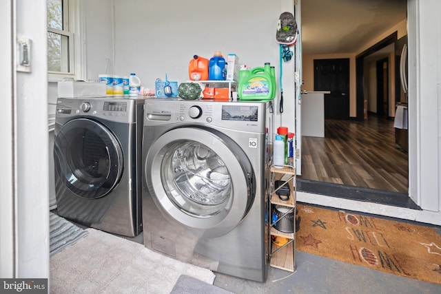 laundry area with washer and dryer and dark hardwood / wood-style floors