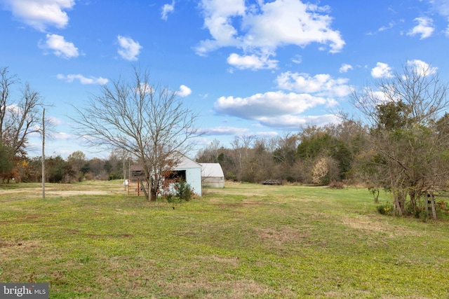 view of yard featuring an outbuilding and a rural view