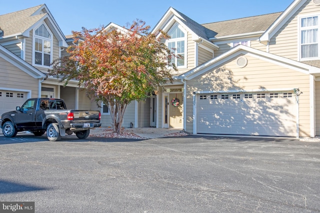 multi unit property featuring a garage