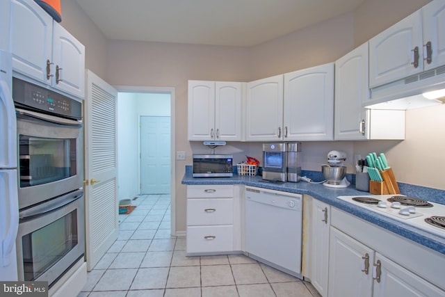 kitchen with white cabinetry, light tile patterned floors, and stainless steel appliances