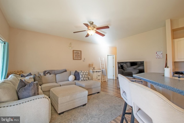 living room featuring ceiling fan and light hardwood / wood-style flooring