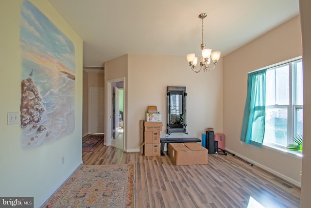 dining room featuring hardwood / wood-style flooring and a notable chandelier