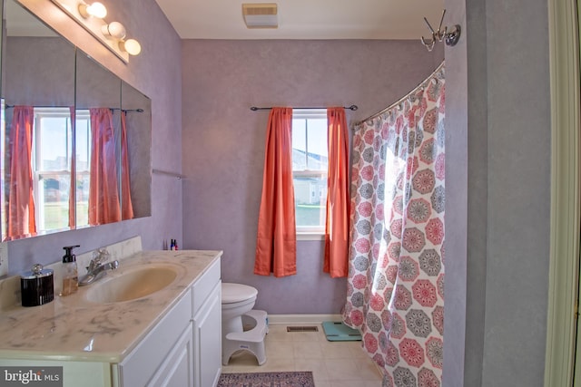 bathroom with curtained shower, vanity, and toilet