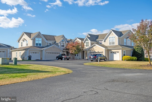 view of front of home featuring a garage and a front yard