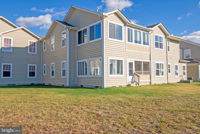 rear view of property with a yard and cooling unit