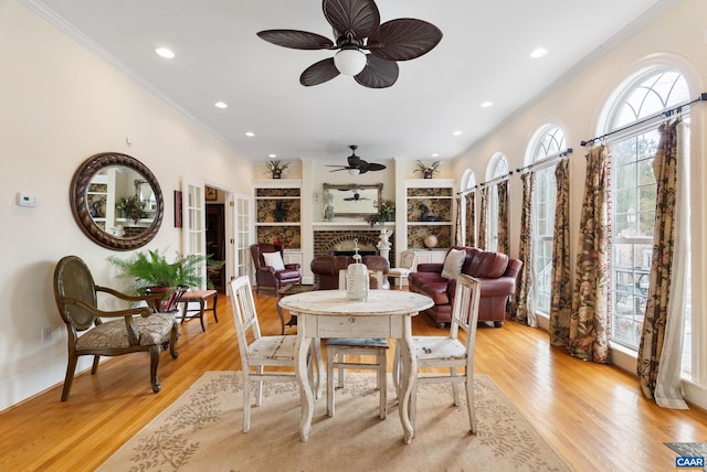 dining area featuring ornamental molding, ceiling fan, and light hardwood / wood-style floors