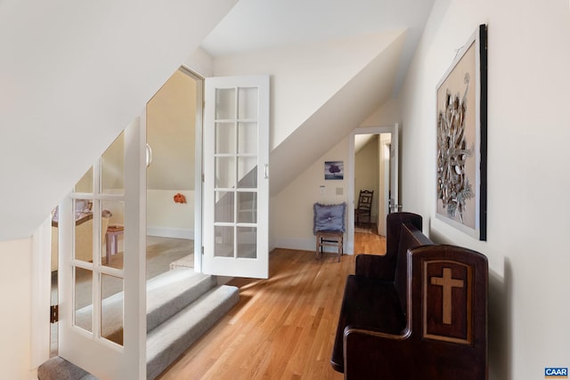 interior space with wood-type flooring and vaulted ceiling