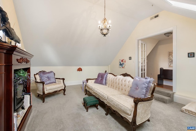 living area with vaulted ceiling, carpet flooring, and a notable chandelier