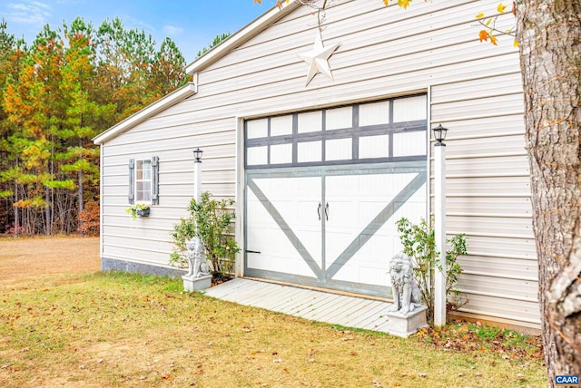 view of outbuilding with a garage and a yard