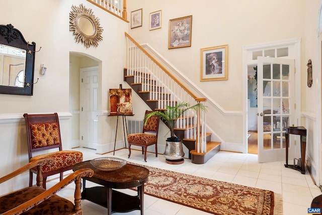 interior space featuring a high ceiling and tile patterned flooring