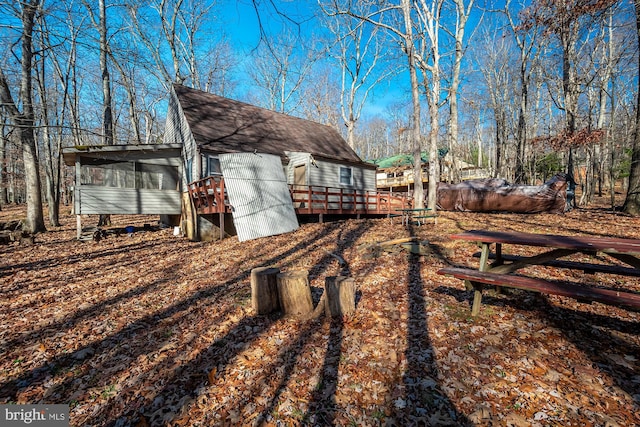 view of yard featuring a deck and a sunroom