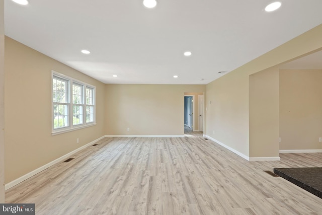 unfurnished room with light wood-type flooring