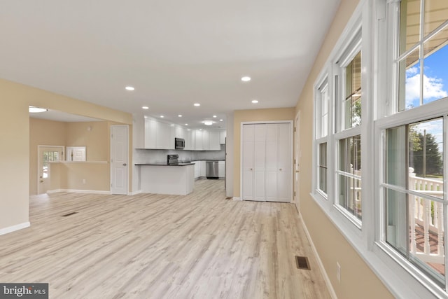 unfurnished living room featuring light wood-type flooring