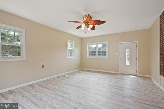 foyer with ceiling fan, a healthy amount of sunlight, and light hardwood / wood-style flooring